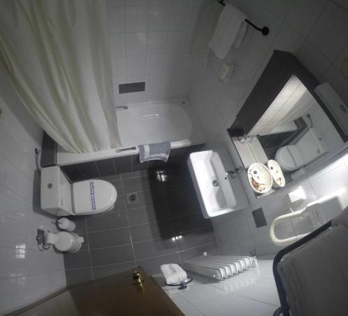 a small bathroom with a sink and a mirror at Apartment Hotel Athina in Alexandroupoli