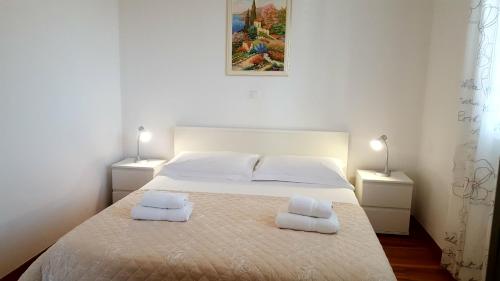 a bedroom with a bed with two towels on it at Apartment Mia in Hvar