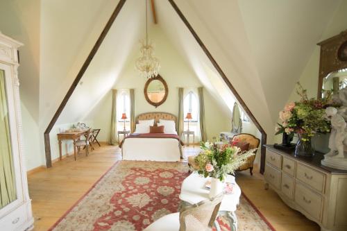 a bedroom with a bed in a room with an attic at The French Country House, Tauranga in Omokoroa Beach
