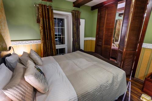 a bedroom with a bed and a window at Chateau Nightingales in Hostouň