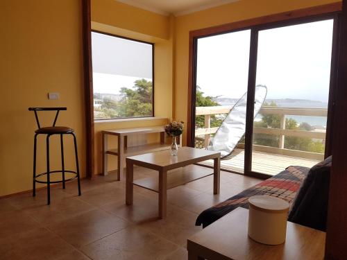 a living room with a view of a balcony at Cabaña Vista Bahia Algarrobo in Algarrobo