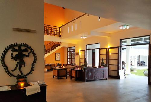 a living room with a staircase in a house at IMAGINE Villa Hotel in Mirissa