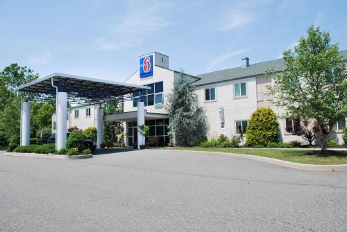 a hotel with a gas station in front of it at Motel 6-Pottstown, PA in Pottstown