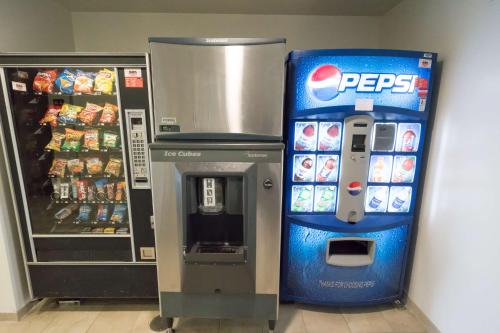 a pepsi vending machine next to a soda machine at Motel 6-Pottstown, PA in Pottstown