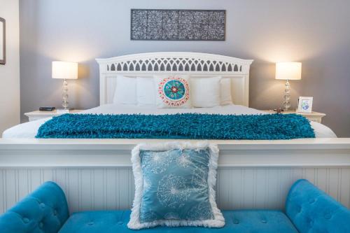 a bedroom with a large white bed with blue pillows at Orlando Escape in Orlando