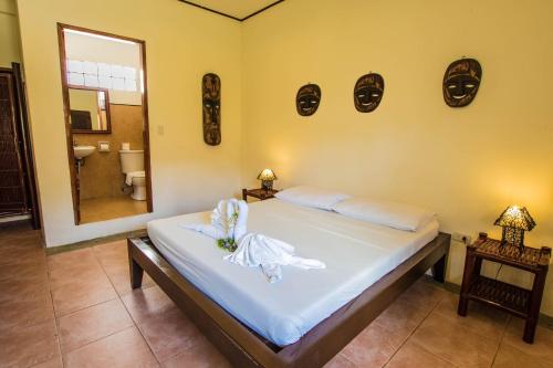 a bedroom with a bed with a angel on it at Levantin Boracay in Boracay