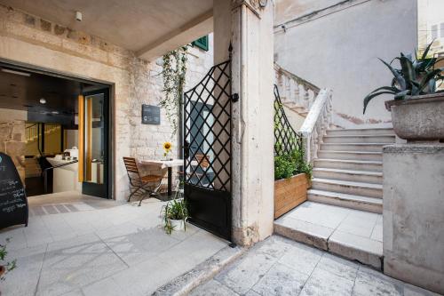 an entrance to a building with a door and stairs at Slavija Culture Heritage Hotel in Split