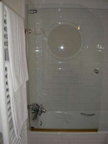 a bathroom with a shower with a sink and a tub at Hotel el Jardín de Eugenia in Ribadesella