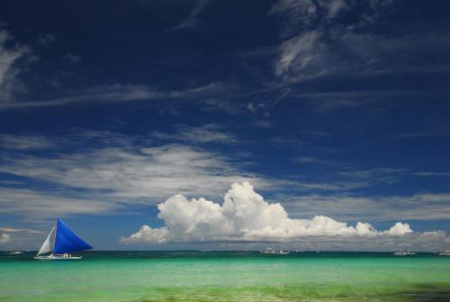 a sail boat in the water on a beach at Levantin Boracay in Boracay