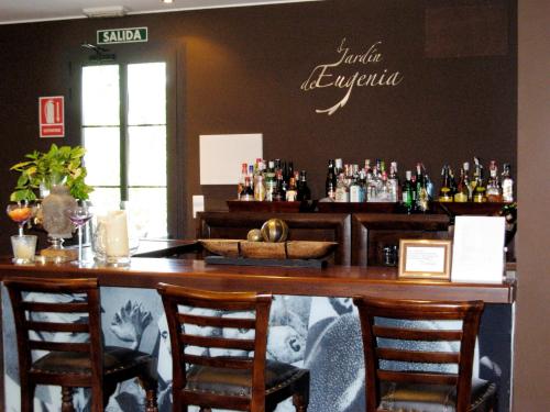 
a bar with a wooden table and chairs at Hotel el Jardín de Eugenia in Ribadesella
