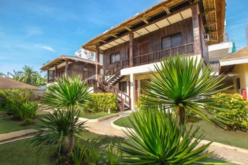 a building with palm trees in front of it at Levantin Boracay in Boracay