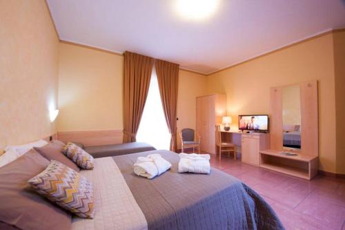 a bedroom with a large bed with two pillows on it at La Collina Hotel & Spa in Oliveto Citra