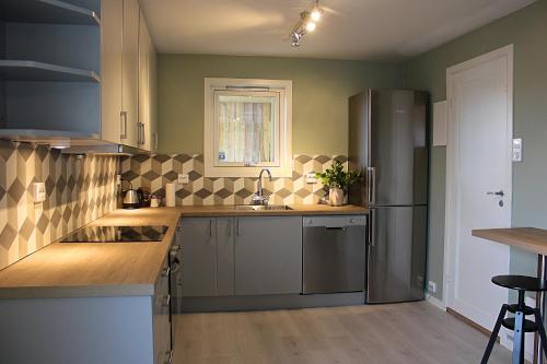 a kitchen with a sink and a refrigerator at City View Studio Apartment in Ålesund