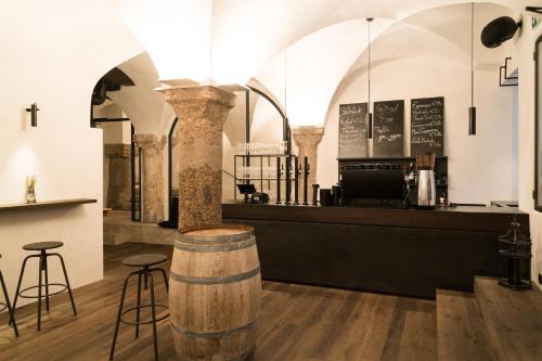 a bar with a barrel in the middle of a room at Boutiquehotel Weisses Rössl in Innsbruck