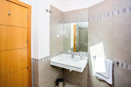 een badkamer met een wastafel en een spiegel bij The Old Town Apartment in Marbella