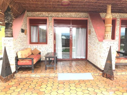 a patio of a house with a couch and a table at Inside Afrika Boutique Hotel in Kigali