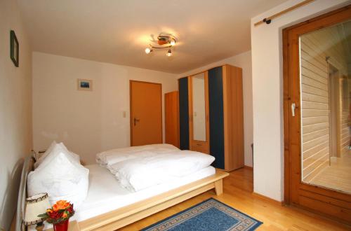a bedroom with a white bed in a room at Haus St. Christoph in Mayrhofen
