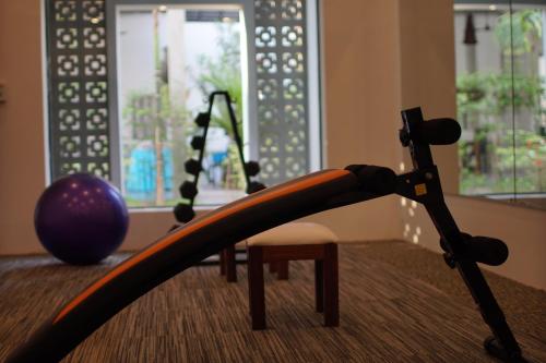 a room with a gym with a exercise ball and a chair at Tanei Angkor Resort and Spa in Siem Reap