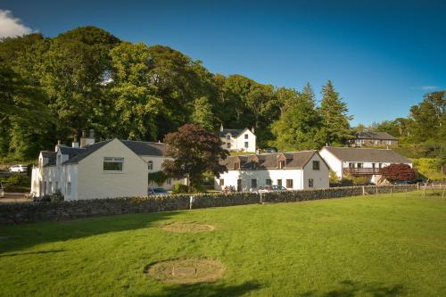 a group of houses and a yard with a grass field at Melfort Village in Oban