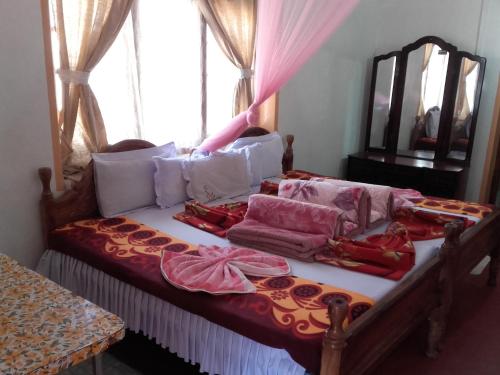 a bed in a room with a window at Bel View Guest House in Haputale