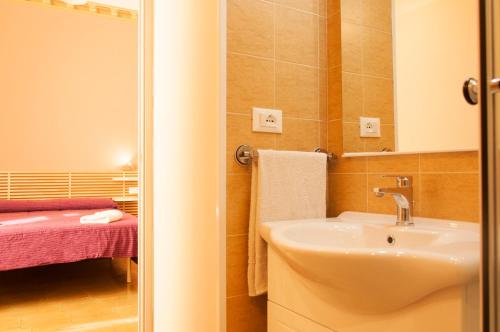 a bathroom with a sink and a mirror at Rooms Palazzo Paladini in Lecce