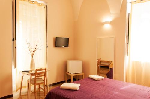 Postel nebo postele na pokoji v ubytování Rooms Palazzo Paladini