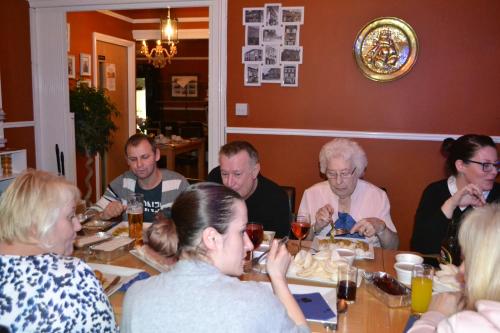 a group of people sitting at a table eating at Waterfront Hotel in Deal