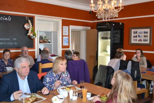 a group of people sitting at tables in a restaurant at Waterfront Hotel in Deal