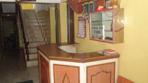 a kitchen with a counter and a mirror in a room at Naga Palace in Gokarna