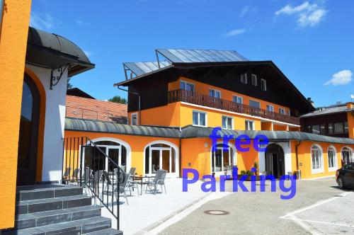 a building with a parking lot in front of it at Hotel Austria in Gablitz