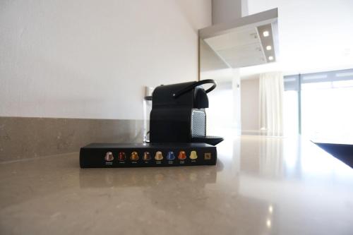a black appliance sitting on top of a kitchen counter at Mezger Lodges in Domburg
