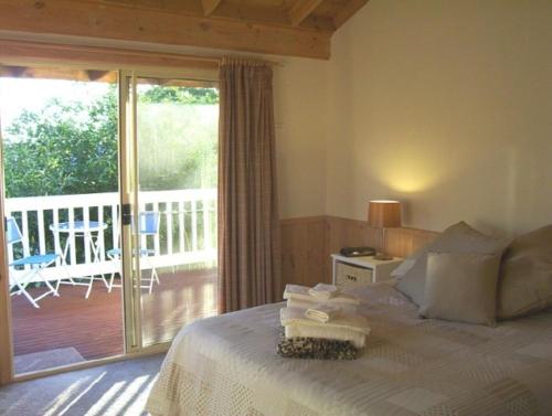 a bedroom with a bed and a balcony with a patio at Yarra Glen Bed & Breakfast in Yarra Glen