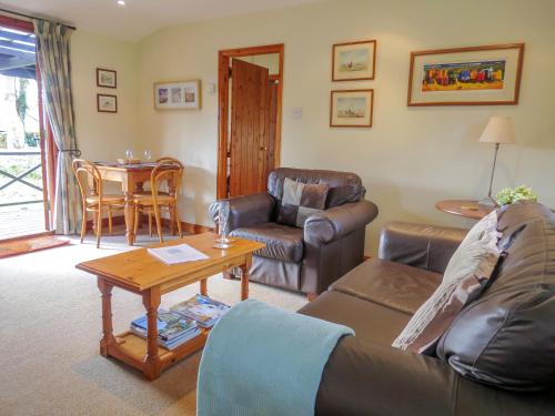 a living room with a couch and a table at 7 The Uplands in Thorpeness