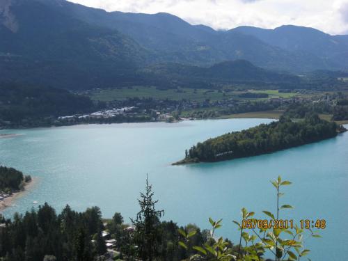 a view of a lake with mountains in the background at Pension-Ferienwohnung Rotar in Faak am See