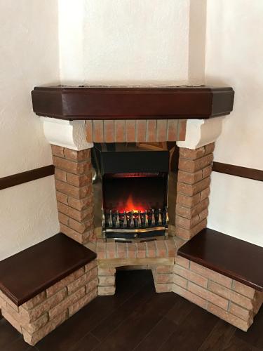 a brick fireplace with a fire in it at Spa-Hotel Myslyvskiy Dvir in Kyiv