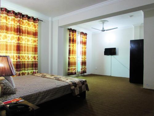 Postel nebo postele na pokoji v ubytování Stargaze Hotel & Apartment