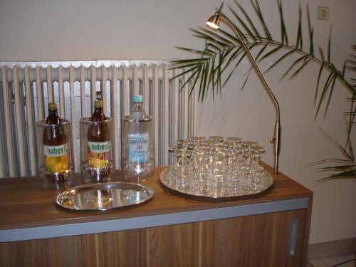 a table with glasses and bottles of alcohol on it at Rhein-Hotel in Andernach