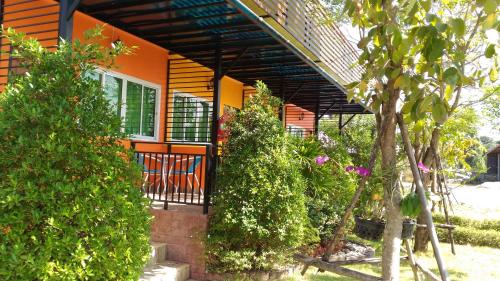 a house with a chair in front of it at Navy Sisatchanalai in Ban Nong Chang