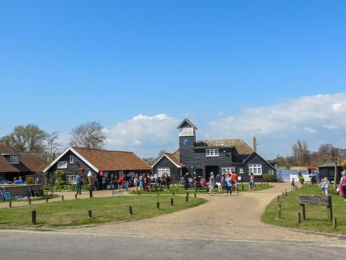 a group of people standing in front of a building at 7 The Uplands in Thorpeness