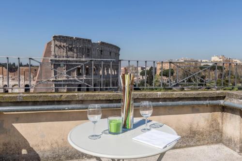
a table that has a vase on top of it at EVE Penthouse Colosseo in Rome
