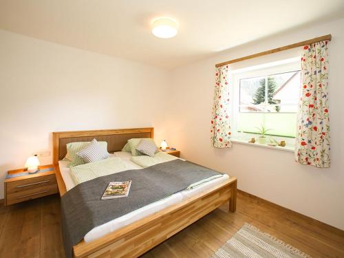 a bedroom with a bed and a window at Ferienhaus Pichler in Niederöblarn