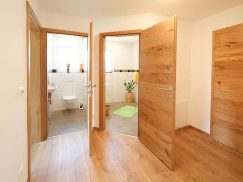 a bathroom with a shower and a toilet and a door at Ferienhaus Pichler in Niederöblarn
