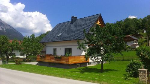 a house with a gambrel roof on a green yard at Ferienhaus Pichler in Niederöblarn