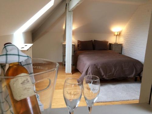 a room with a bed and two wine glasses at Hotel Saint Georges in Mons