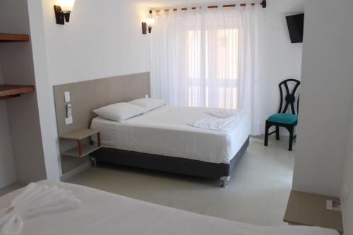Postel nebo postele na pokoji v ubytování Akel House Hotel