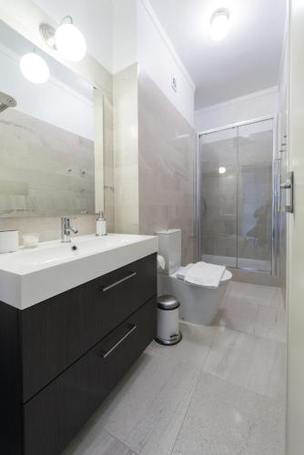 a bathroom with a sink and a shower and a toilet at Beautiful view close to Estádio da Luz in Lisbon