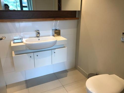 a bathroom with a sink and a toilet at Zimbali Suite 107 in Ballito
