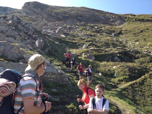a group of people walking on a mountain trail at Aktiv Hotel Zur Rose am Brenner in Steinach am Brenner