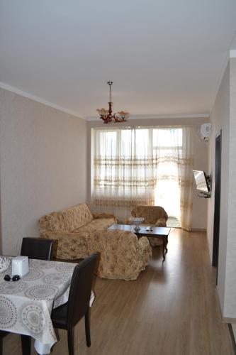 ein Wohnzimmer mit einem Sofa und einem Tisch in der Unterkunft batumi apartment 173 in Batumi