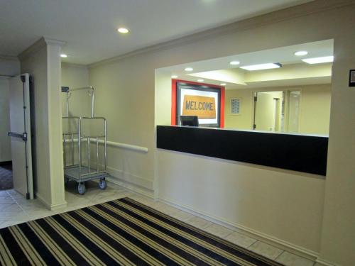 a lobby of a waiting room with a luggage cart at Extended Stay America Suites - Boston - Burlington in Burlington